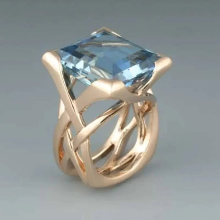Elegante roségouden ring met blauwe zirkonia